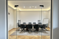 The conference room has a capacity of 11 people at the table or 35 as presentation