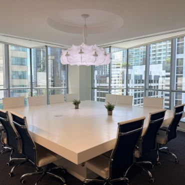 Spacious and professional conference room ideal for team meetings, presentations, training sessions, and workshops. Features a large table, comfortable seating, TV, and dry-erase board, with a flexible setup to accommodate different meeting needs.