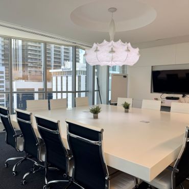 Spacious and professional conference room ideal for team meetings, presentations, training sessions, and workshops. Features a large table, comfortable seating, TV, and dry-erase board, with a flexible setup to accommodate different meeting needs.