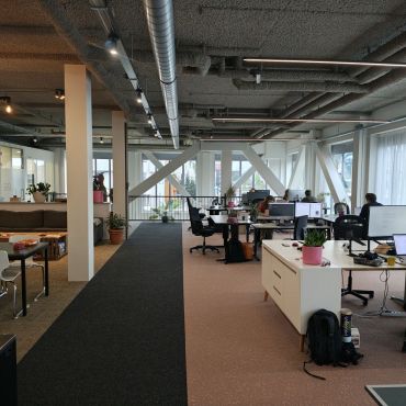 Our office on the first floor. With lots of natural light, 15 desks, a pingpong table and meeting rooms.