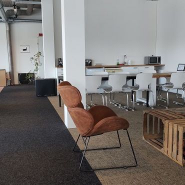 The other half of our office. With a chill couch, a long table for long lunches and a kitchen.