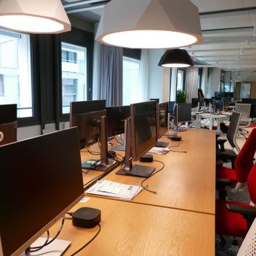 Fully equipped workstations with monitors, standing desks, and ergonomic chairs for comfortable day-to-day work.