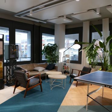 Open lounge space for informal work, conversations, and downtime, including a ping pong table.