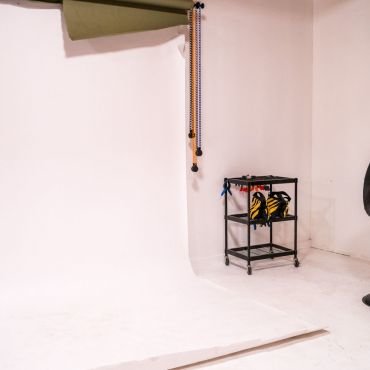 Photography studio 
24 foot white wall and floor set up
Nine-foot wall-mounted backdrops (black & grey) with lots of room for full lighting
Hair and Make-up station, fridge with water, cups and room for craft services. 
Private change room, whiteboard, comfortable seating, WiFi, storage and locker.
Light stands, sandbags, and other assorted gear available upon request

Amenities
Many unique on-location photo opportunities nearby. 
Street parking available, street level loading bay. 
Talent lounge, shower, access to espresso machine and kegerator in coworking space. 
