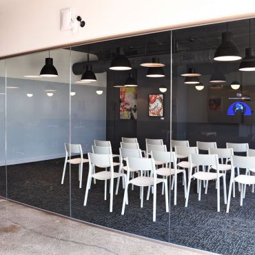 Large private meeting room in space that can accommodate up to 35 people theater style (no tables) or 24 people with tables.