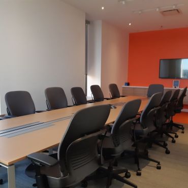 Boardroom with a capacity to seat 14 people with a smart TV and conference phone